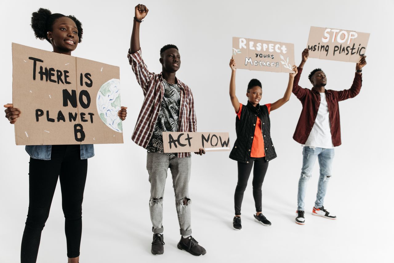 Mastering the First Impression: Your intriguing post title goes here Diverse group of young adults holding environmental protest signs indoors on a white background.